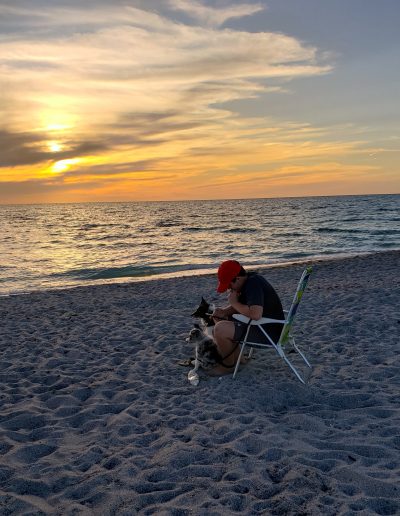 A teenage boy and his border collies on the beach in Florida.