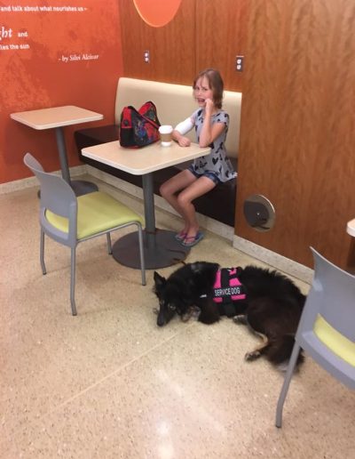 A border collie service dog and his handler in the cafeteria of the hospital.