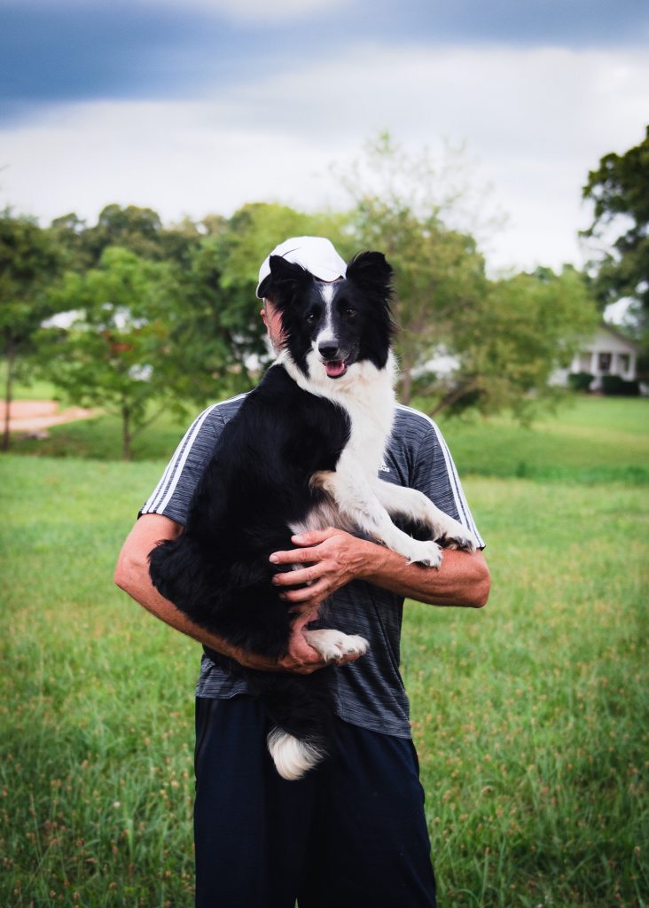 Molly, a black and white Border Collie, loves to jump into Jason's arms.